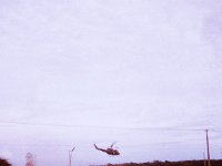 Huey helicopter landing near the battery.